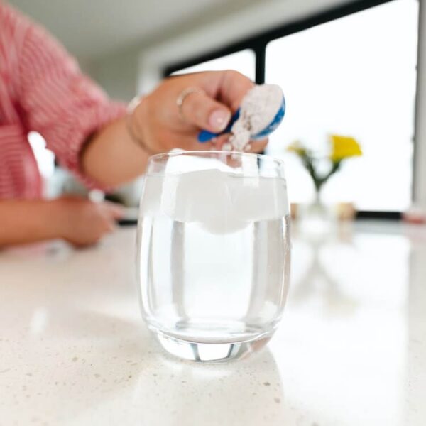 Powder supplement being added to water.